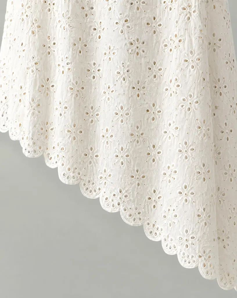 Close-up of the asymmetric scallop skirt embroidery and finishing
