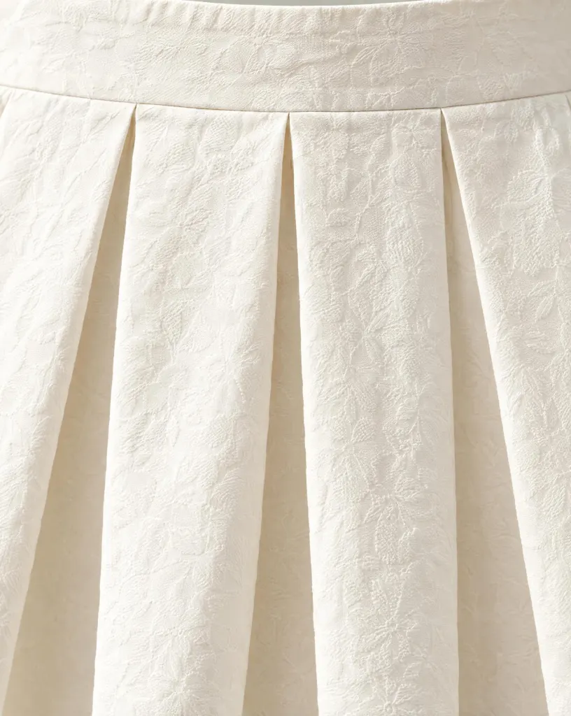 Close-up of the box-pleat pocket skirt embroidery and finishing