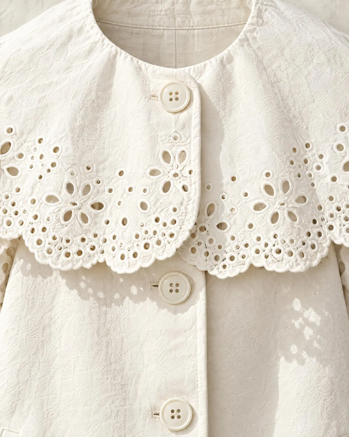 Close-up of the cape-collar short coat embroidery and finishing