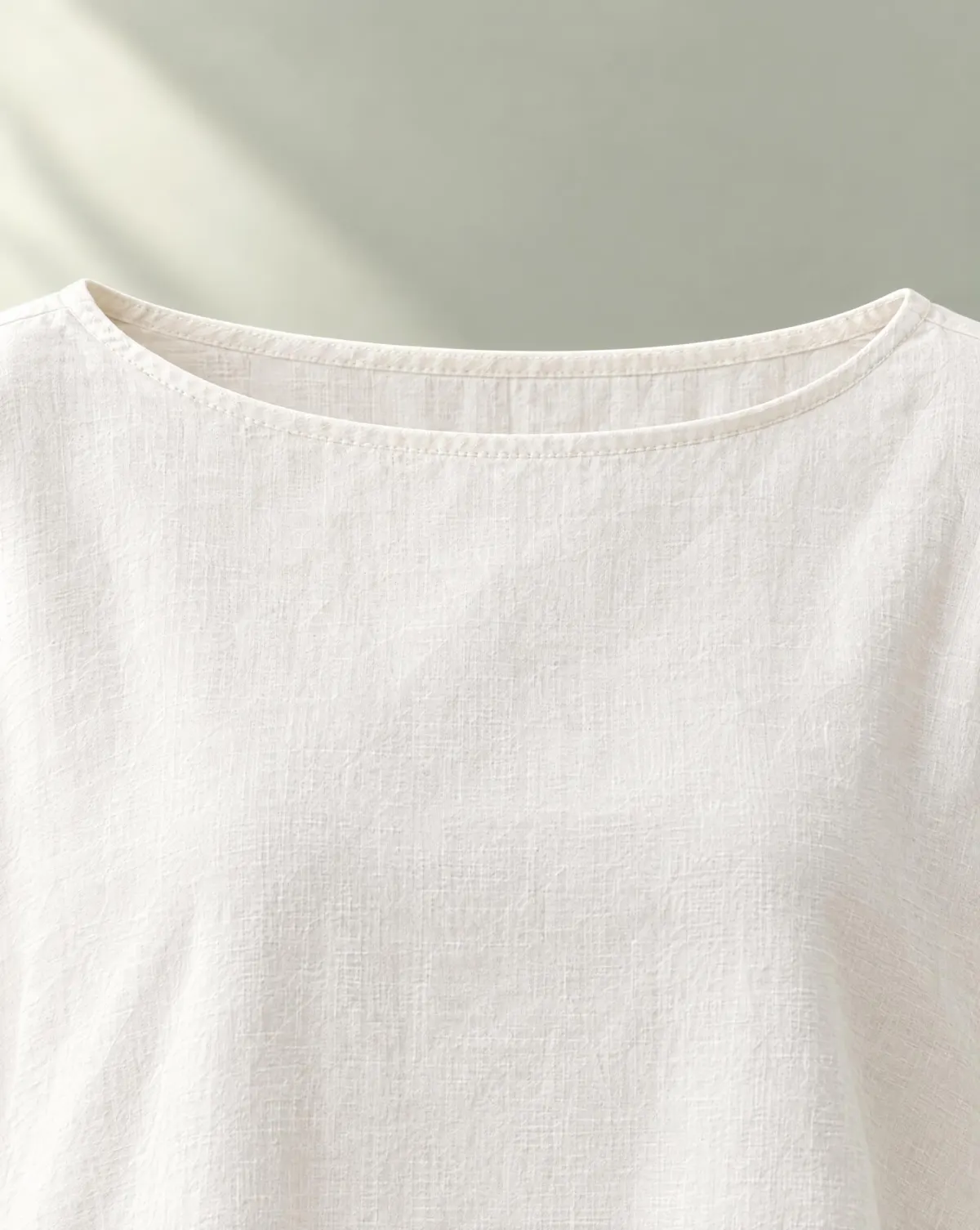 Close-up of the clover boat-neck top embroidery and finishing