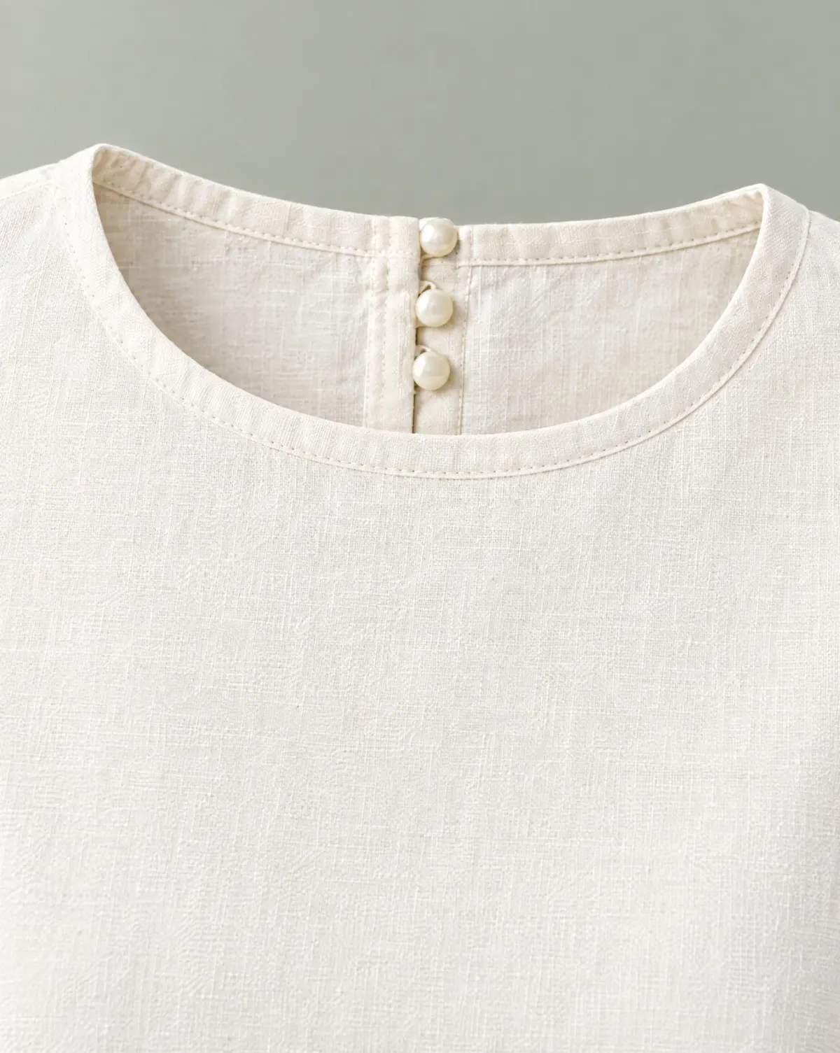 Close-up of the petal scallop-cuff crop top embroidery and finishing