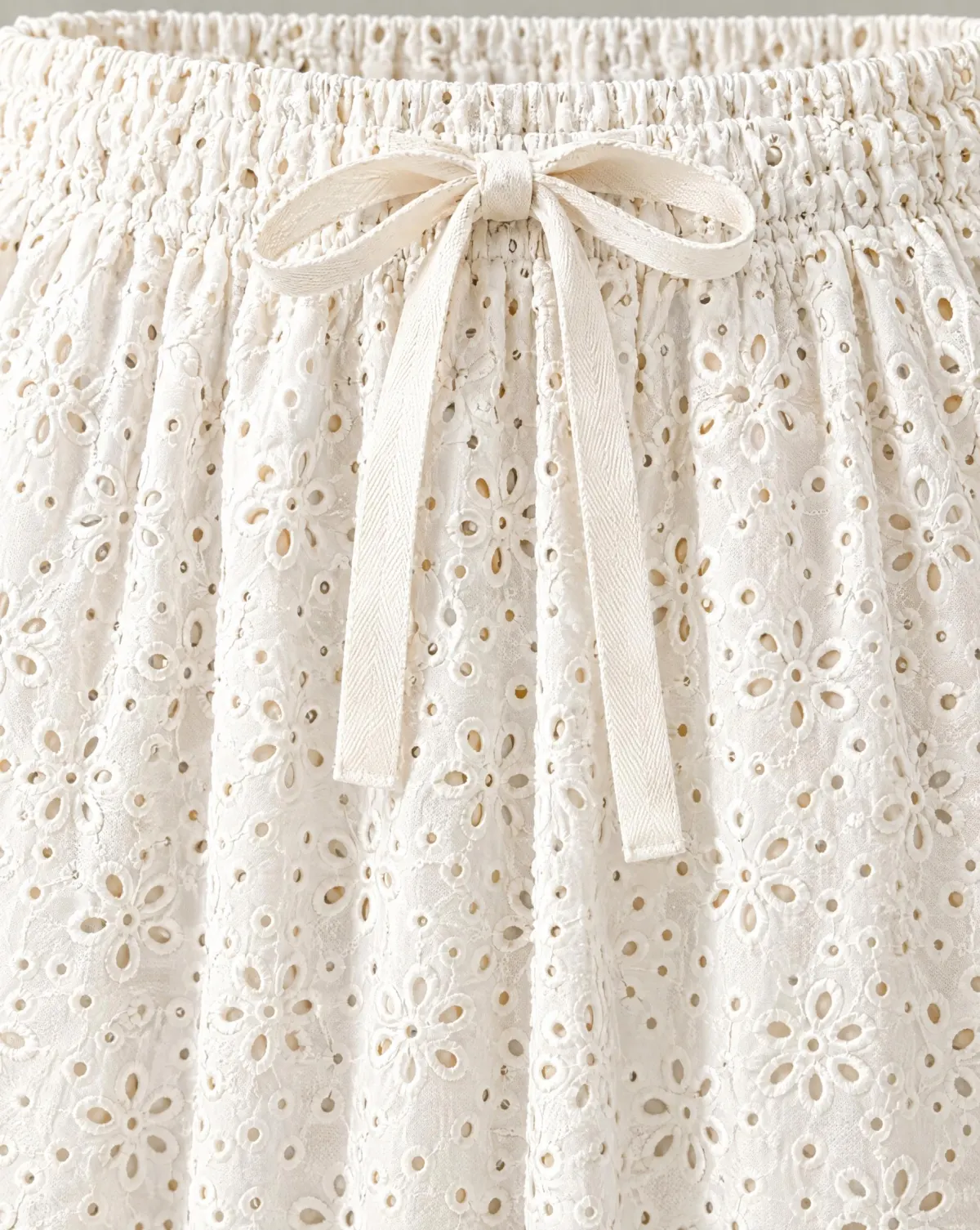 Close-up of the ribbon-waist knee skirt embroidery and finishing