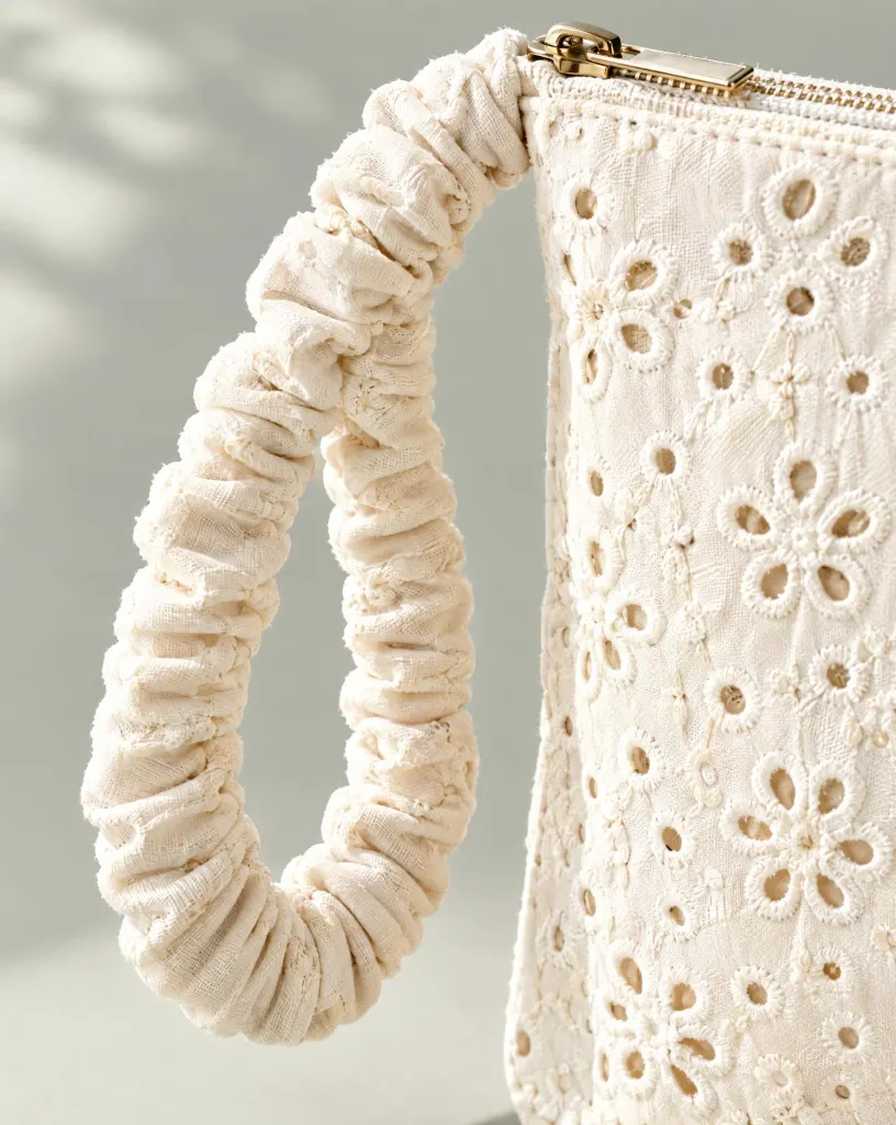 Close-up of the ruched-handle wristlet embroidery and finishing