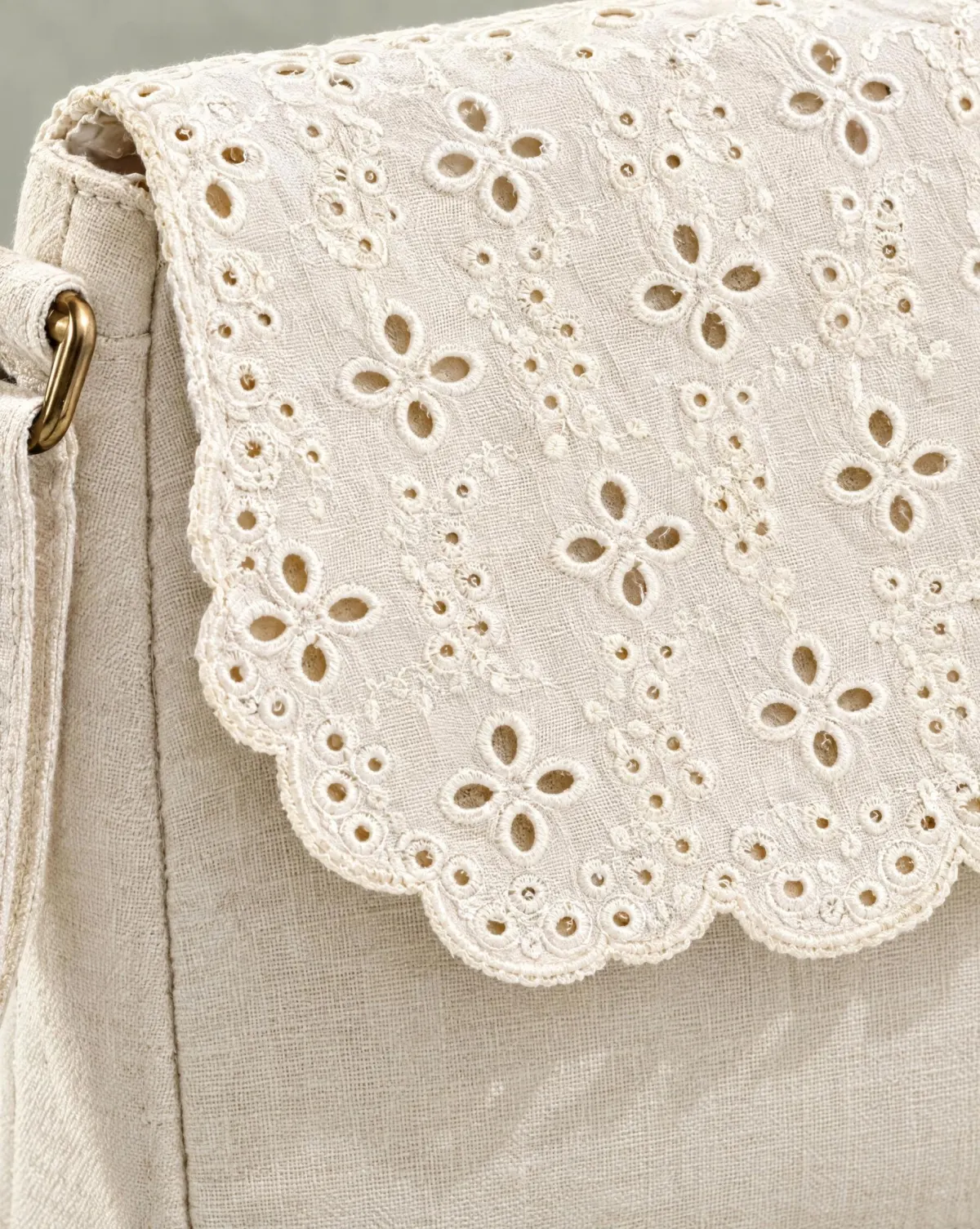 Close-up of the scallop-flap crossbody embroidery and finishing