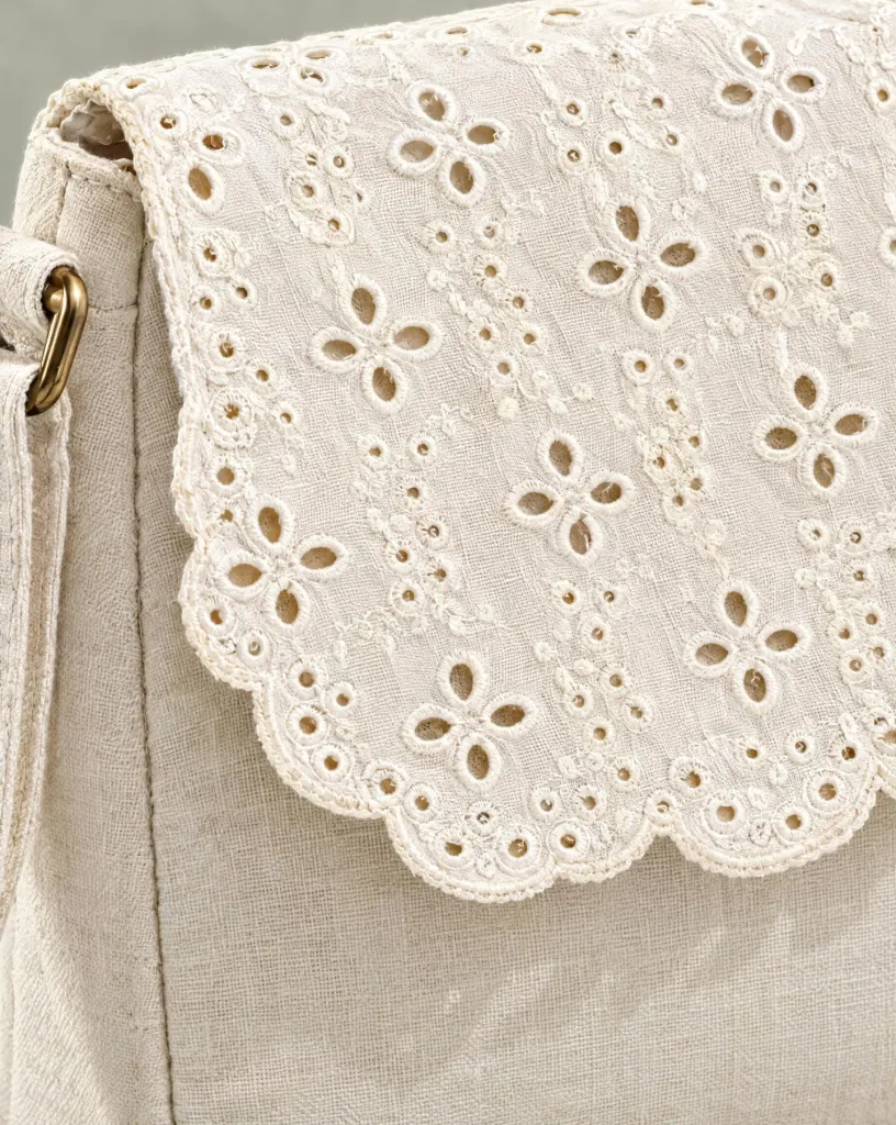 Close-up of the scallop-flap crossbody embroidery and finishing