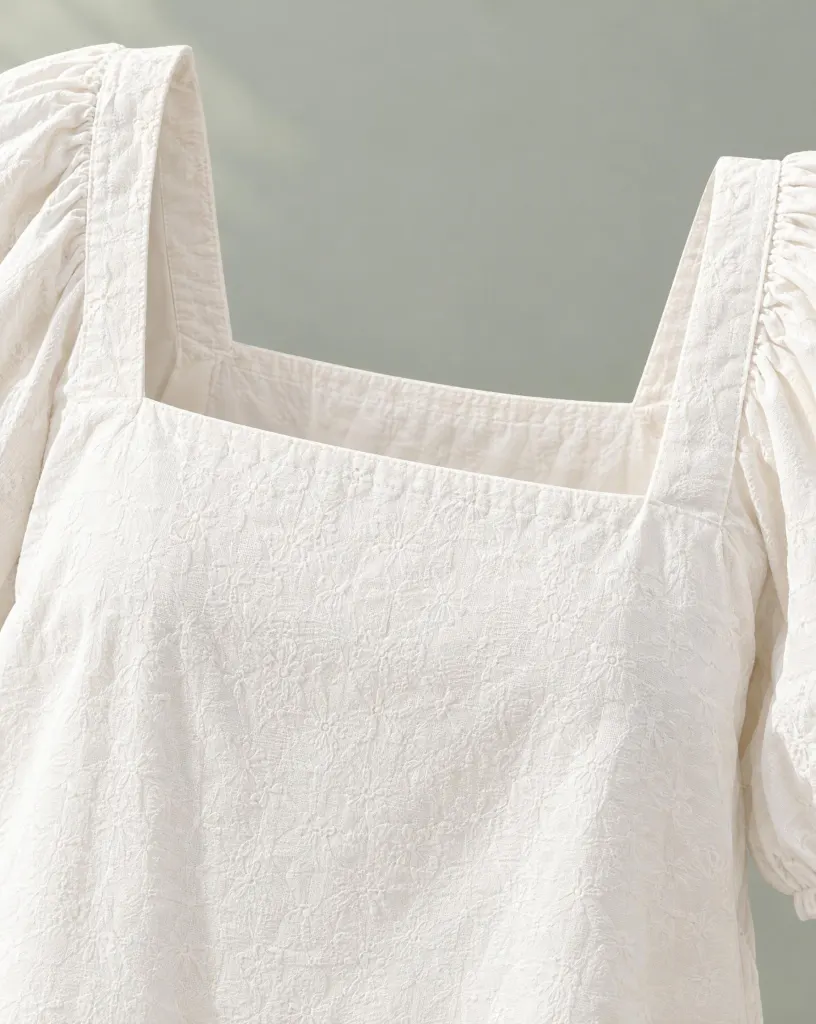 Close-up of the sill square-neck eyelet top embroidery and finishing