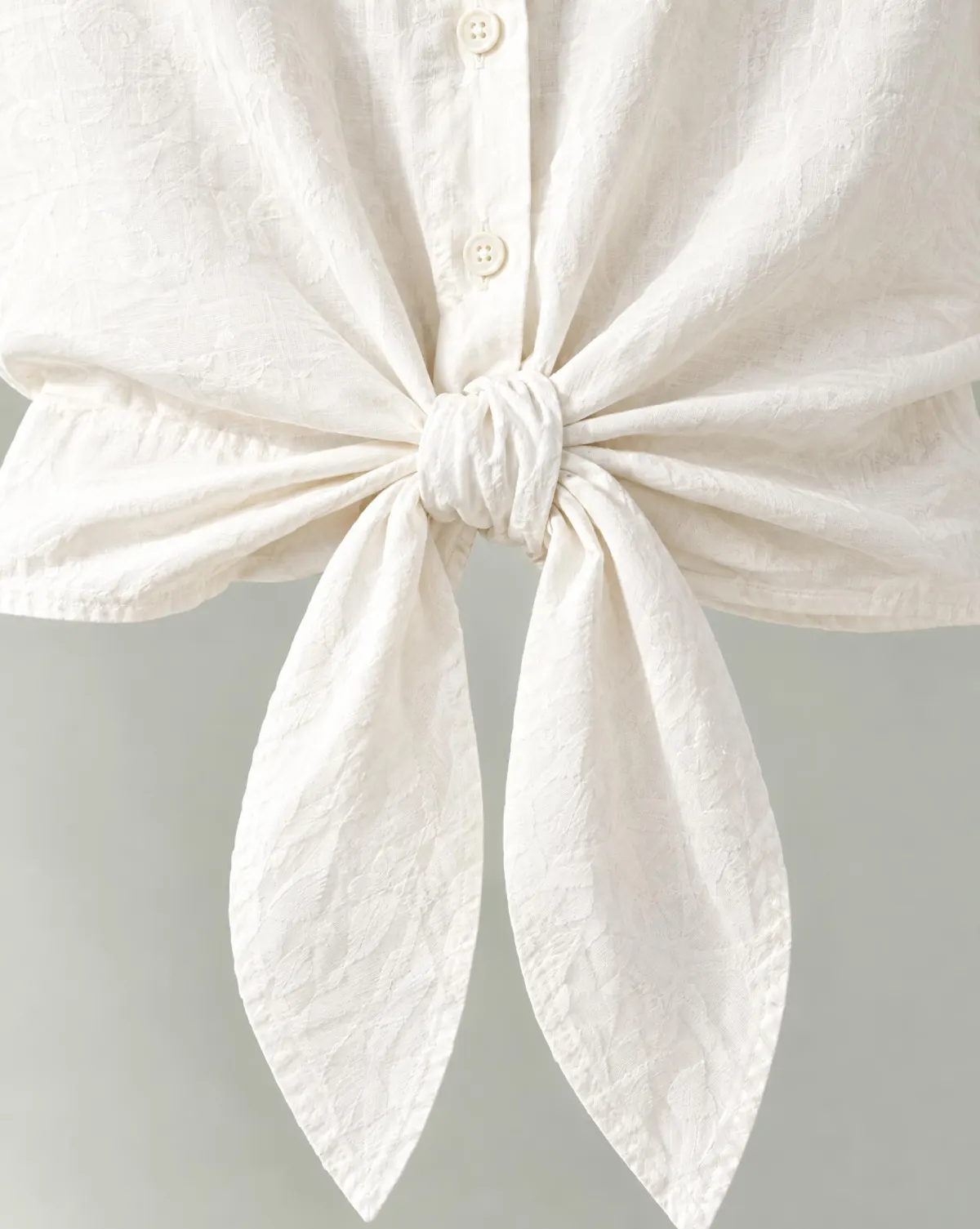 Close-up of the tie-front short overshirt embroidery and finishing